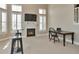 Bright living room featuring a fireplace, tall windows, and a functional workspace area at 5426 Dtc Pkwy, Greenwood Village, CO 80111