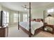 Spacious bedroom with a four-poster bed, ceiling fan, and bright natural light at 5426 Dtc Pkwy, Greenwood Village, CO 80111
