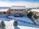 Aerial view of home's backyard and deck in winter at 19427 Dunraven St, Parker, CO 80134