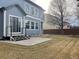 This is a lovely backyard with a cement patio, grassy area, and sliding glass doors to let the sunshine in at 1022 Morning Dove Dr, Longmont, CO 80504