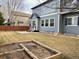 Spacious backyard with lawn, patio area, garden bed, and a two-story home featuring blue siding at 1022 Morning Dove Dr, Longmont, CO 80504