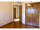 Empty bedroom with hardwood floors, closet, and bright natural light at 1022 Morning Dove Dr, Longmont, CO 80504