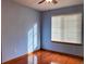 Cozy bedroom featuring hardwood floors, ceiling fan and a bright window at 1022 Morning Dove Dr, Longmont, CO 80504