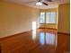 Bright empty bedroom with hardwood floors and a bay window allowing ample natural light at 1022 Morning Dove Dr, Longmont, CO 80504