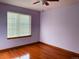Bedroom with hardwood floors, a ceiling fan and natural light streaming through the window at 1022 Morning Dove Dr, Longmont, CO 80504