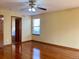Empty bedroom with hardwood floors, walk-in closet, and door leading into the bathroom at 1022 Morning Dove Dr, Longmont, CO 80504