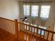 View from the second floor balcony down to the foyer with the high ceilings and large windows at 1022 Morning Dove Dr, Longmont, CO 80504