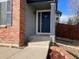 Inviting front entrance with a dark blue door, brick accents, and well-maintained landscaping at 1022 Morning Dove Dr, Longmont, CO 80504