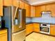 Close up of the kitchen with stainless steel refrigerator and oven set against beautiful wood cabinets at 1022 Morning Dove Dr, Longmont, CO 80504