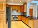 Spacious kitchen with honey oak cabinets, stainless steel appliances, granite countertops and tiled backsplash at 1022 Morning Dove Dr, Longmont, CO 80504