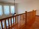 Second floor landing features hardwood floors, wood railings, and a view of windows with lots of natural light at 1022 Morning Dove Dr, Longmont, CO 80504