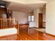 Open living space with hardwood floors, staircase, and a glimpse into adjacent rooms, offering a spacious feel at 1022 Morning Dove Dr, Longmont, CO 80504
