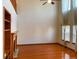 Bright living room with hardwood floors, fireplace, and soaring ceilings with large windows and natural light at 1022 Morning Dove Dr, Longmont, CO 80504