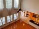 Living room with tall windows, hardwood floors, ceiling fan and eat-in kitchen at 1022 Morning Dove Dr, Longmont, CO 80504