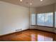 Spacious living room with hardwood floors, neutral walls, and ample natural light from large windows at 1022 Morning Dove Dr, Longmont, CO 80504