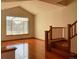 Well-lit living room featuring hardwood floors, a staircase with wooden railings, and a large window at 1022 Morning Dove Dr, Longmont, CO 80504