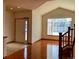 Bright living room with hardwood floors, vaulted ceilings, and large windows offering ample natural light at 1022 Morning Dove Dr, Longmont, CO 80504