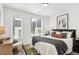 Comfortable bedroom with large windows, stylish bedding, and a cozy sitting area at 5128 W 26Th Ave # 101, Denver, CO 80212
