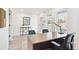 Well-lit home office with a sleek desk, comfortable seating, and a modern aesthetic with large windows at 5128 W 26Th Ave # 101, Denver, CO 80212
