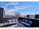 Chic rooftop deck with comfortable sofas and a great view at 5128 W 26Th Ave # 101, Denver, CO 80212