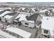 Aerial view of the house with covered patio and snow-covered yard at 5622 Shadescale Way, Castle Rock, CO 80104