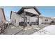 Covered back porch with stylish seating, barbecue grill, and convenient access to the house and backyard at 5622 Shadescale Way, Castle Rock, CO 80104