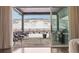 Inviting back porch featuring elegant wicker furniture, grill and winter landscape views at 5622 Shadescale Way, Castle Rock, CO 80104