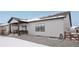 View of the covered back porch and gravel yard in a snow covered back yard at 5622 Shadescale Way, Castle Rock, CO 80104