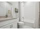 Bathroom featuring white subway tile in shower and neutral vanity with brushed nickel hardware at 5622 Shadescale Way, Castle Rock, CO 80104