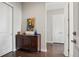 Inviting entryway featuring hardwood floors, a stylish console table, and a convenient closet for coats and storage at 5622 Shadescale Way, Castle Rock, CO 80104