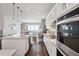 Gourmet kitchen with stainless steel appliances, large island, and elegant tile backsplash at 5622 Shadescale Way, Castle Rock, CO 80104