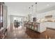 Bright open concept living area with hardwood floors, fireplace, and gourmet kitchen island at 5622 Shadescale Way, Castle Rock, CO 80104