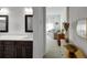 Double vanity bathroom with a view into a sitting area at 11220 Bellsong Ln, Littleton, CO 80125