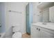 Bright bathroom featuring a vanity with cabinet storage, a matching mirror, and a toilet at 857 S Van Gordon Ct # I207, Lakewood, CO 80228