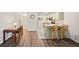 Open floor plan with dining area leading to a contemporary kitchen and a glimpse into the bathroom at 857 S Van Gordon Ct # I207, Lakewood, CO 80228