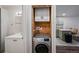 Efficient laundry closet with modern washer, overhead storage, and conveniently situated near the updated kitchen at 857 S Van Gordon Ct # I207, Lakewood, CO 80228