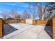 Large concrete parking area in backyard with a storage shed at 495 S Olive Way, Denver, CO 80224