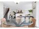 View of the dining room with a glass table and stylish decor at 9603 Marmot Ridge Cir, Littleton, CO 80125