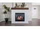 Elegant living room fireplace with decorative mantle and hearth, hardwood floors, and plenty of natural light at 9603 Marmot Ridge Cir, Littleton, CO 80125