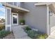 Inviting front porch with a potted plant, glass front door, and neutral siding and trim at 9603 Marmot Ridge Cir, Littleton, CO 80125