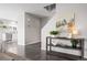 Bright and airy living room with wood floors, stylish decor, and an open layout flowing into the kitchen at 9603 Marmot Ridge Cir, Littleton, CO 80125