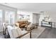 Bright living room boasts modern decor, an open layout, and seamless connection to the adjacent kitchen at 9603 Marmot Ridge Cir, Littleton, CO 80125