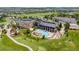 Overhead view of a community clubhouse, pool, and golf course, surrounded by greenery and walking paths at 7501 S Addison Way, Aurora, CO 80016