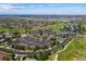 Expansive aerial view of a community clubhouse with golf course, tennis courts, and lush landscaping at 7501 S Addison Way, Aurora, CO 80016