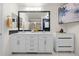Stylish bathroom with double vanity, ample storage, modern fixtures, and hexagon tile floors at 7501 S Addison Way, Aurora, CO 80016