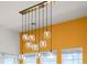 Modern chandelier with glass globe shades over a dining area at 7501 S Addison Way, Aurora, CO 80016