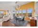 Bright dining room with modern chandelier, rug, and backyard view at 7501 S Addison Way, Aurora, CO 80016