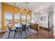 Bright dining area with multiple windows, rug, and stylish lighting at 7501 S Addison Way, Aurora, CO 80016