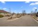 Community entrance with brick signage, well-manicured landscaping, and a gated entry for added security at 7501 S Addison Way, Aurora, CO 80016