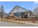 Charming single-Gathering house with a welcoming front porch and attractive stonework details at 7501 S Addison Way, Aurora, CO 80016